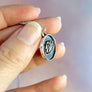 side view showing shadowbox style of brain pendant with a smooth rounded border