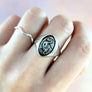 dodo ring being worn on middle finger