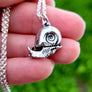 backside of silver snail charm showing XF makers mark and 925 hallmark