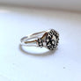 side view of alien ring in sterling silver, showing UFO inspired details on the side of the band