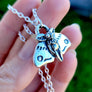 close up of adorable 3D mothman pendant necklace in silver