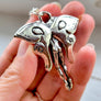 backside of mothman pendant showing cute cheeks and wing details as well as 925 and XF hallmarks