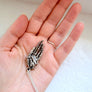 hand pendant in palm of hand to show scale. 3D open hand pendant in sterling silver