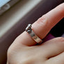 lighter version of frog ring shown being worn on pinky