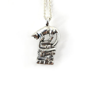 sterling silver cat on a stack on books