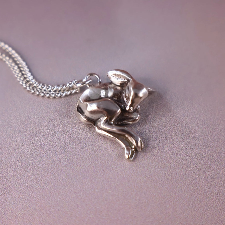 side view of fawn sleeping silver necklace