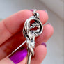 close up of fire breathing dragon detail on silver key pendant