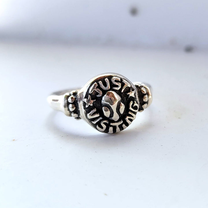signet ring with the words "just visiting" framing an alien head