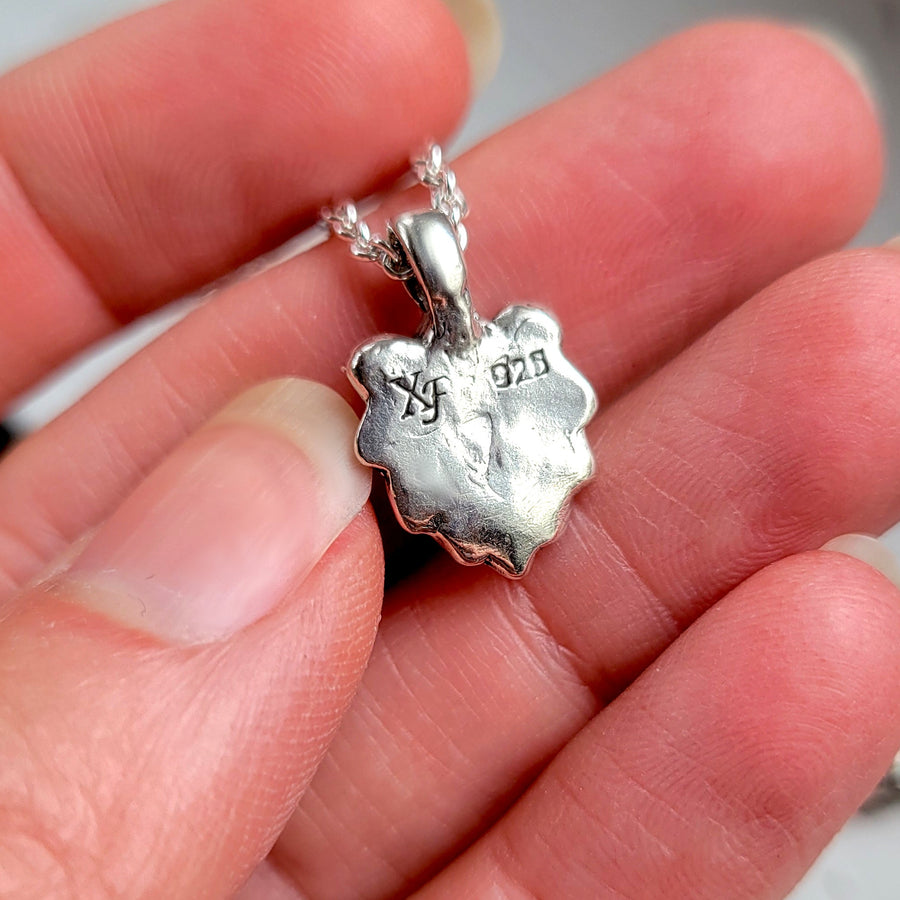 backside of lion charm necklace showing silver hallmark and XF makers mark