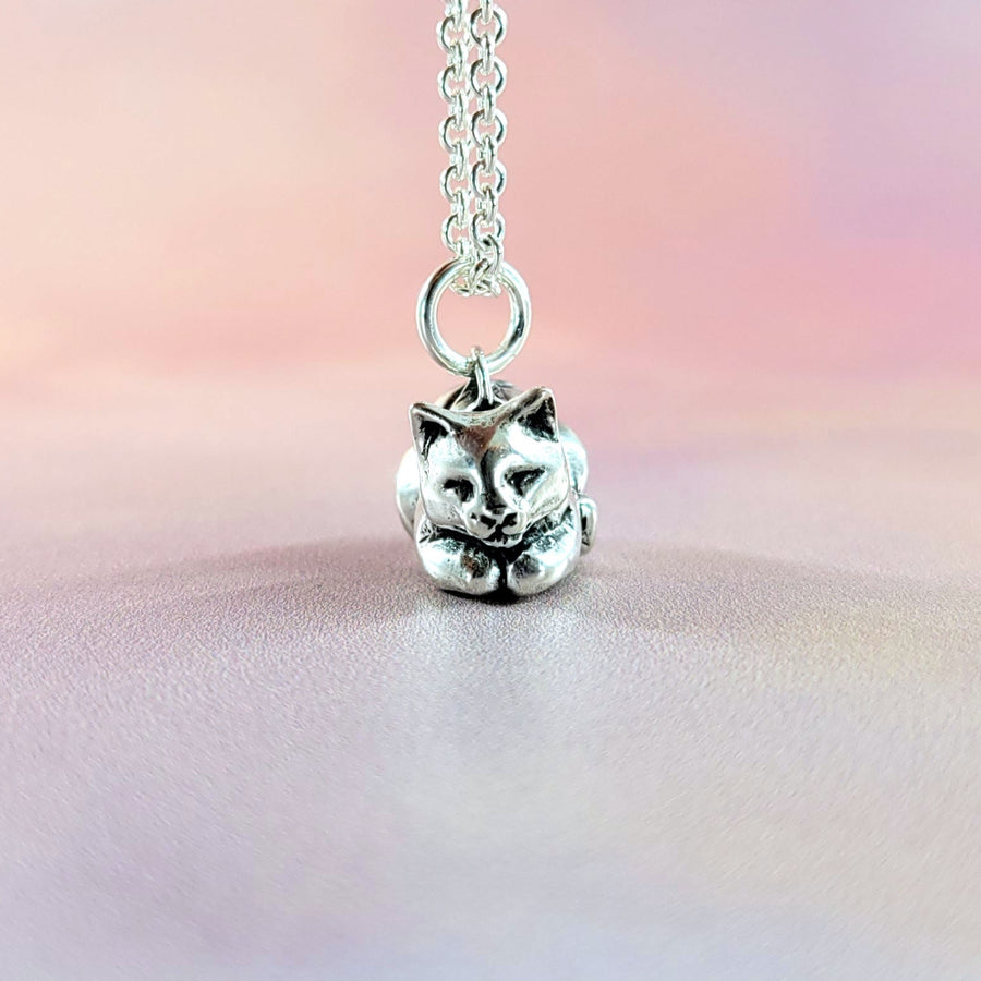 face view of cute sleepy cat charm