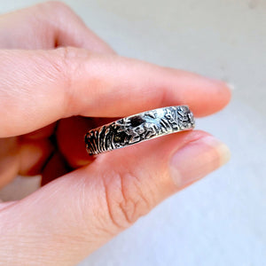white tailed deer buck laying down on handsculpted silver ring