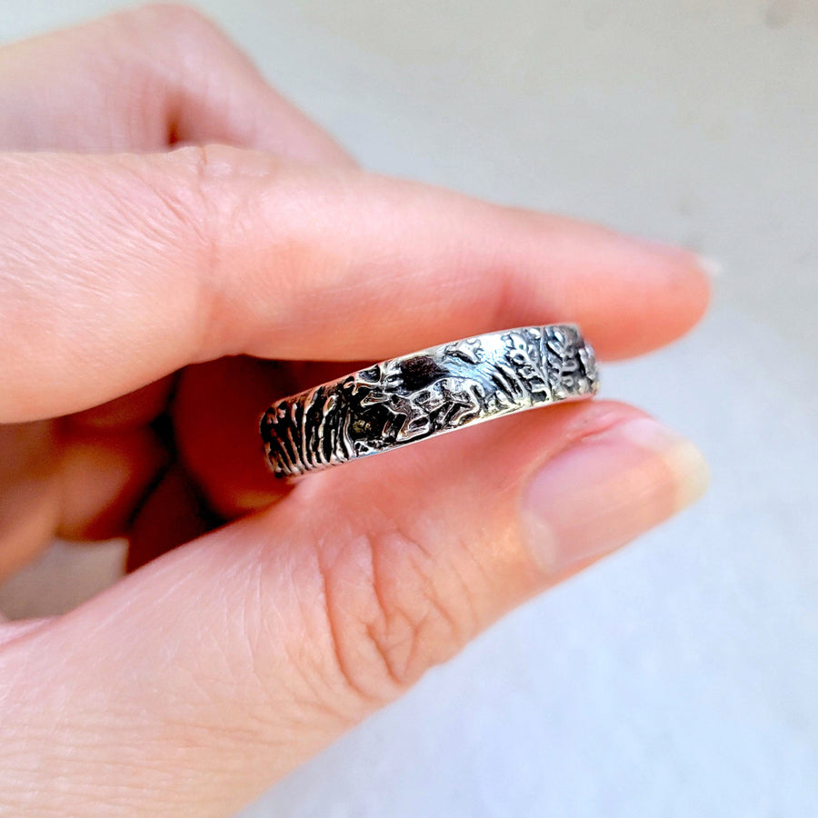 white tailed deer buck laying down on handsculpted silver ring
