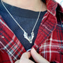 bat necklace shown being worn against black tshirt