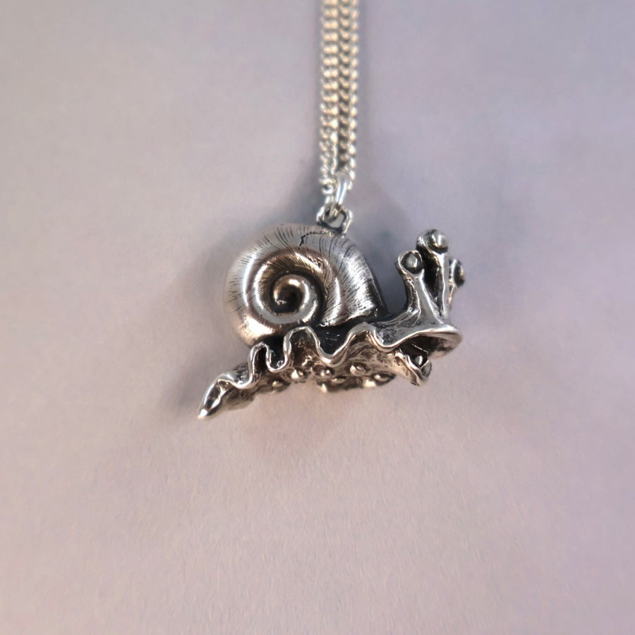snailien pendant hanging nicely on a sterling chain