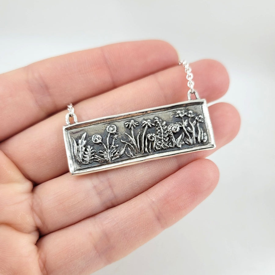 rectangular necklace with relief style flowers